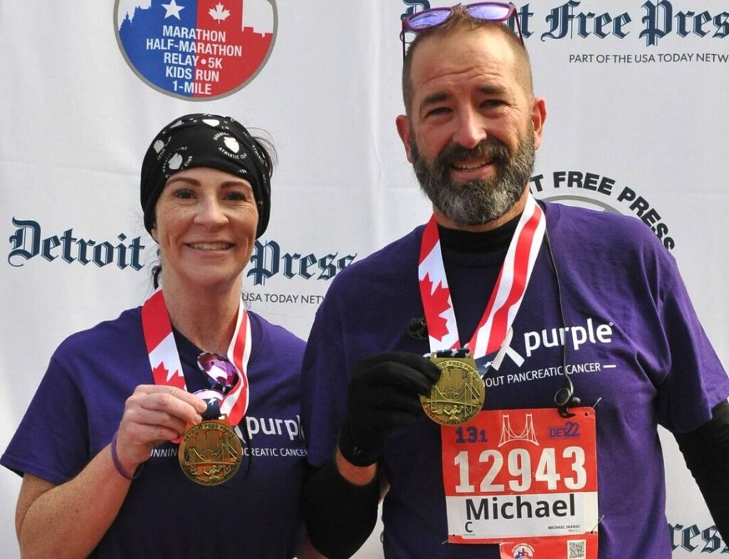 Michael and Missy Skaggs with their medals after running the Detroit Half Marathon in 2022