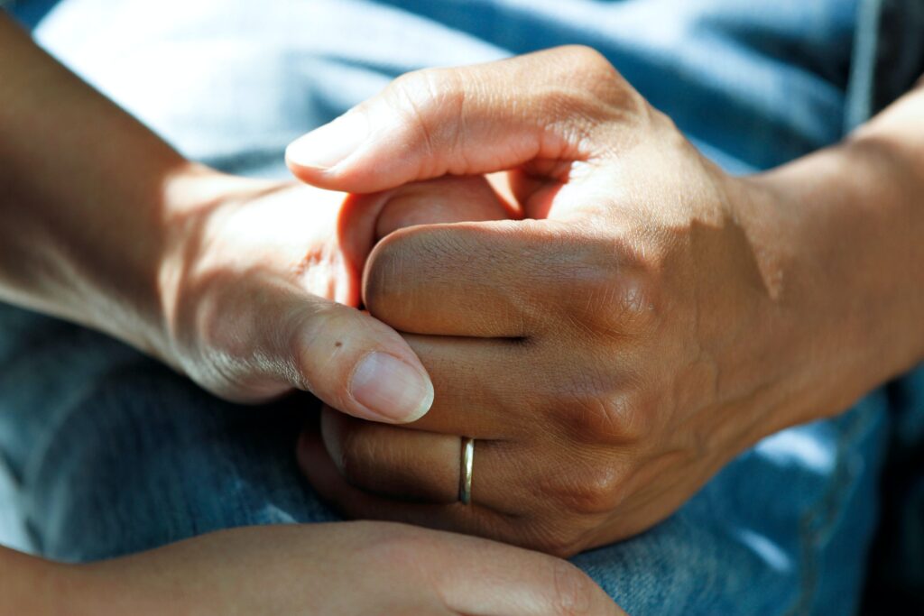 stock photo of patient and caregiver's hands zoomed in