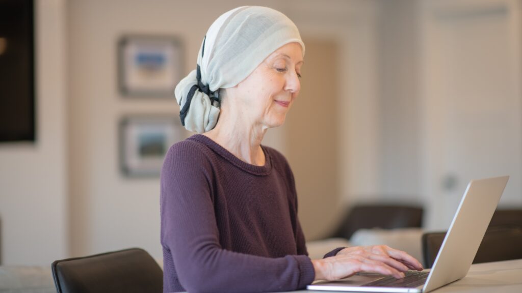 woman with cancer working on laptop