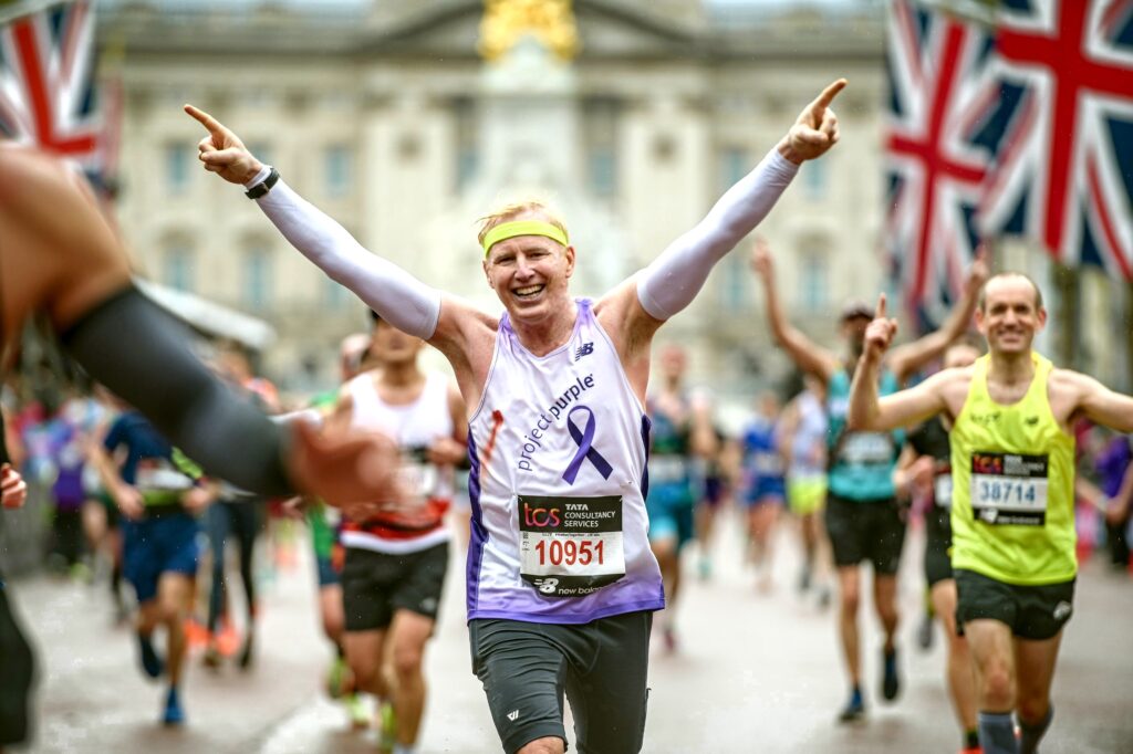 Project Purple runner in London surrounded by UK flags